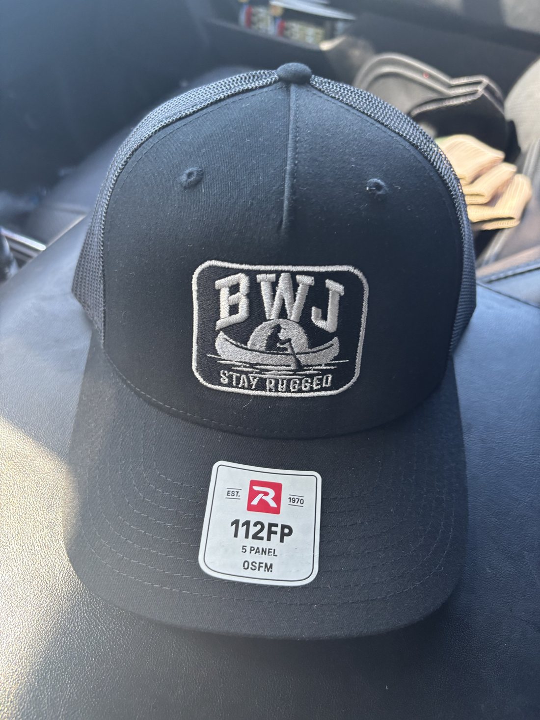 BWJ Stay Rugged Trucker Hat, black with the embroidered BWJ canoe patch
